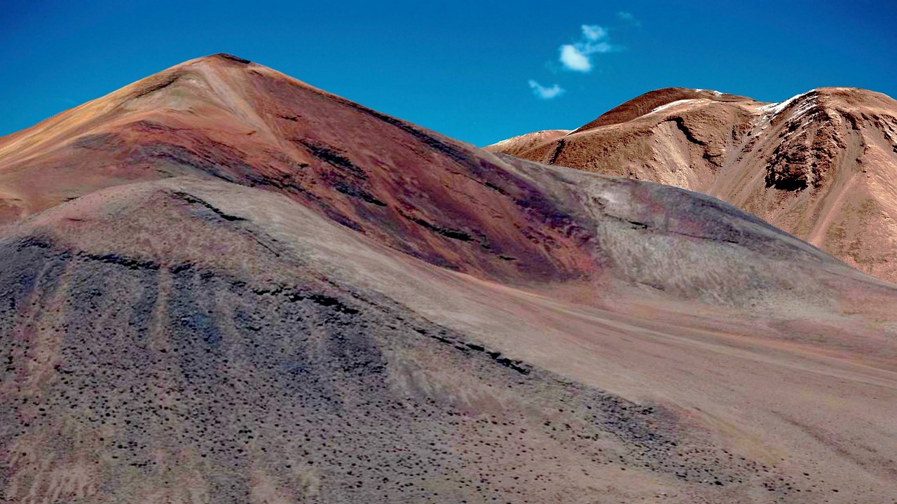 a close up of a mountain with a sky in the background, a colorized photo, by Samuel Birmann, color field, chile, red sand, half moon, downhill landscape