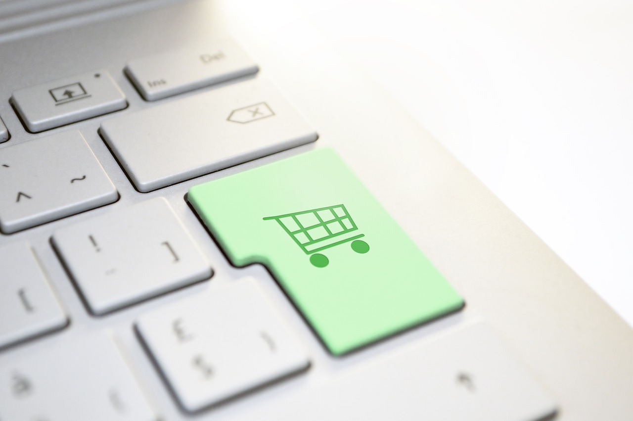a computer keyboard with a green button on it, a stock photo, by Julian Allen, shutterstock, shopping cart icon, close-up product photo, productphoto, on textured base; store website