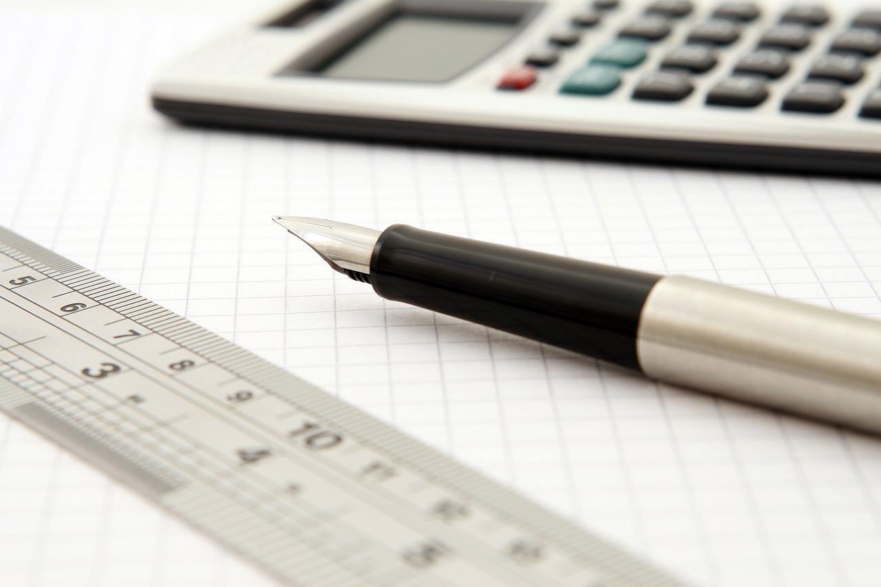 a pen sitting on top of a piece of paper next to a calculator, istockphoto, high details photo, set photo, high res photo