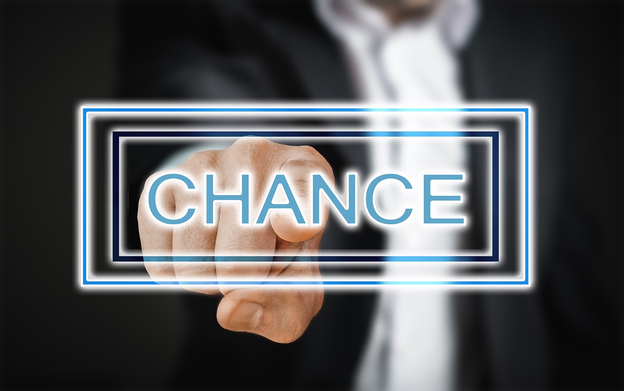 a man in a suit holding a sign that says chance, a digital rendering, trending on pixabay, happening, finger, chiron, stock photo, looking partly to the left