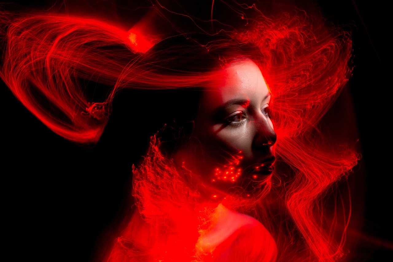 a woman with her hair blowing in the wind, by Adam Marczyński, shutterstock contest winner, digital art, red leds, glowwave girl portrait, fiery red, solo 3 / 4 portait