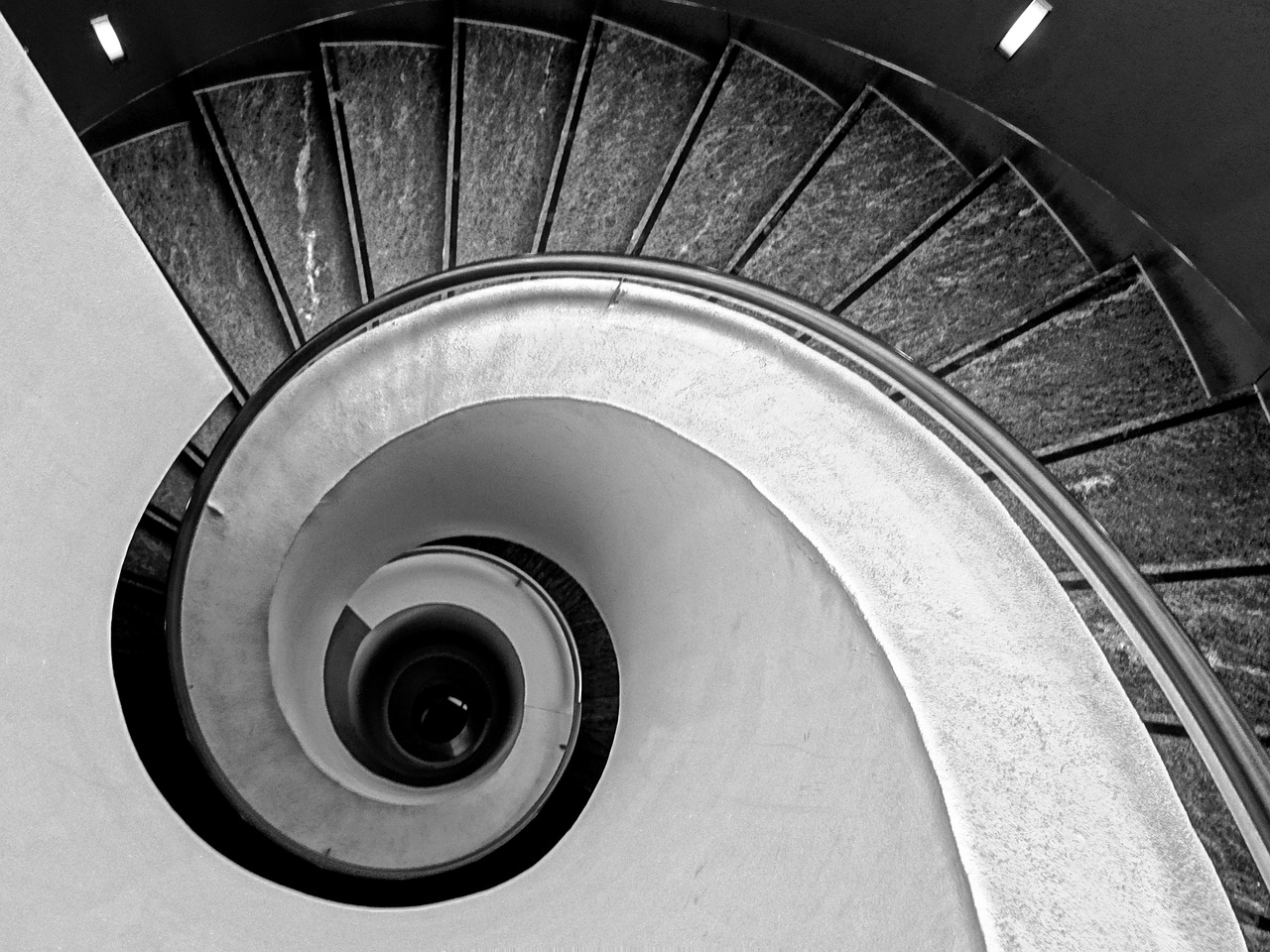 a black and white photo of a spiral staircase, inspired by André Kertész, unsplash, marble!! (eos 5ds r, spiral horns!, whirlpool, follows the golden ratio