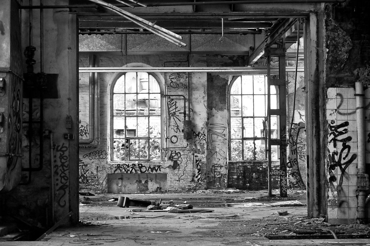 a black and white photo of an abandoned building, graffiti, large open windows, industrial photography, vertical portrait, karen vikke