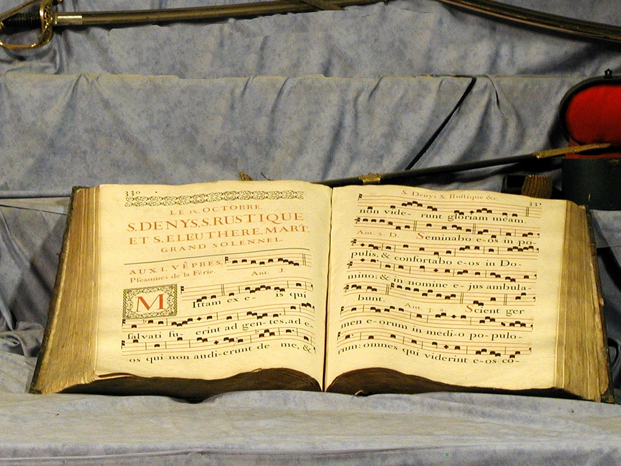 an open book sitting on top of a bed, by Johannes Martini, flickr, baroque, musical instrument, choir, auction catalogue photo, mickael lelièvre