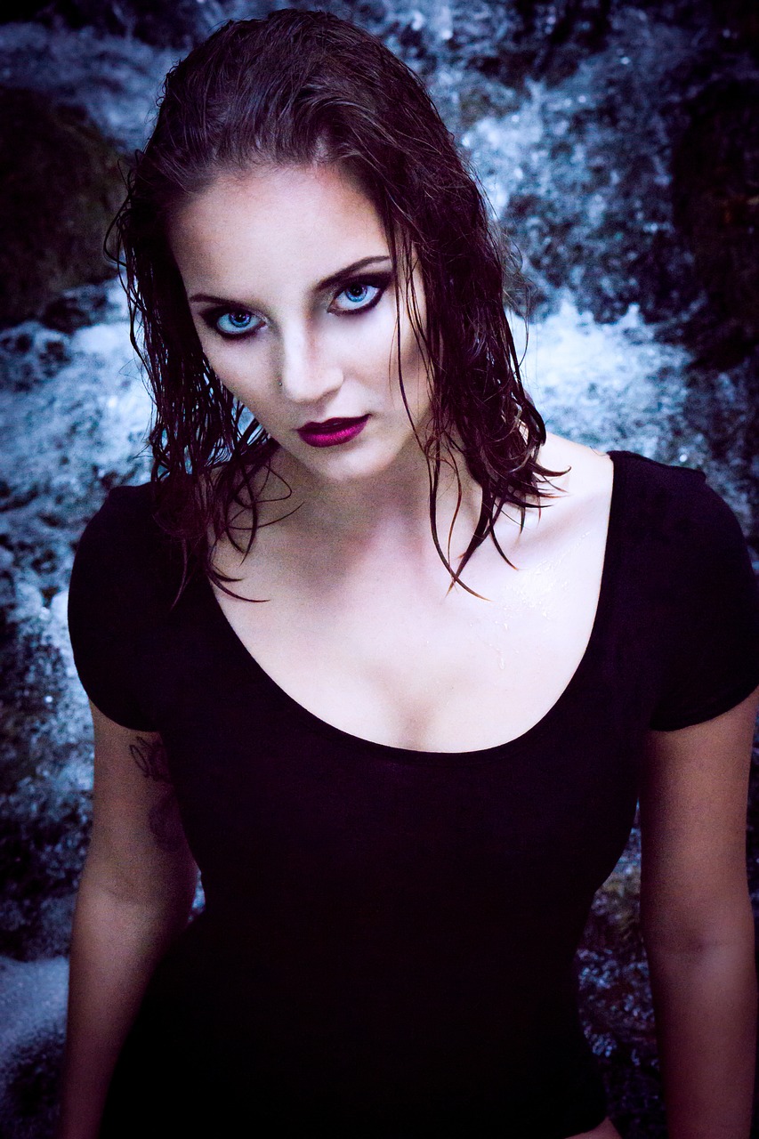 a woman with wet hair posing for a picture, a portrait, by Zoran Mušič, art photography, dark goth queen with blue eyes, standing in front of a waterfall, camilla luddington, dark lipstick