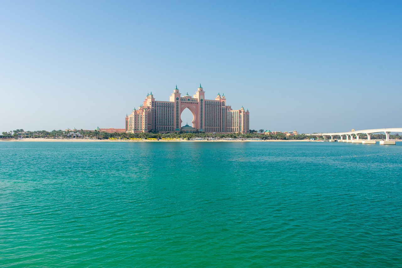 a large building in the middle of a body of water, by Richard Carline, shutterstock, atlantis city, tanned ameera al taweel, turquoise horizon, royal photo