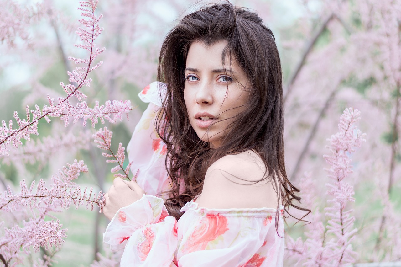 a woman standing in a field of pink flowers, a picture, inspired by Lilia Alvarado, 🤤 girl portrait, lush sakura, portrait sophie mudd, beautiful iranian woman