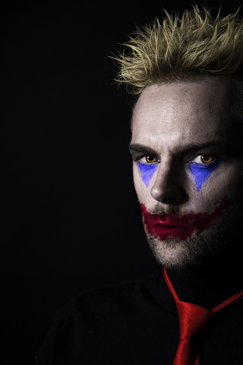 a man with his face painted like a clown, a portrait, inspired by James Bolivar Manson, pexels, pop art, margot robbie as harley quinn, ryan renolds as batman, portrait lighting, pewdiepie