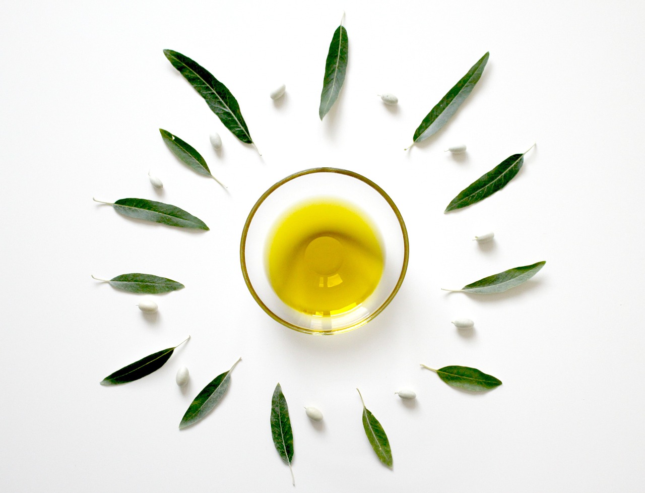 a glass of olive oil surrounded by green leaves, inspired by Ceferí Olivé, minimalism, olga buzova, view from bottom, acroteria, hyperdetailled