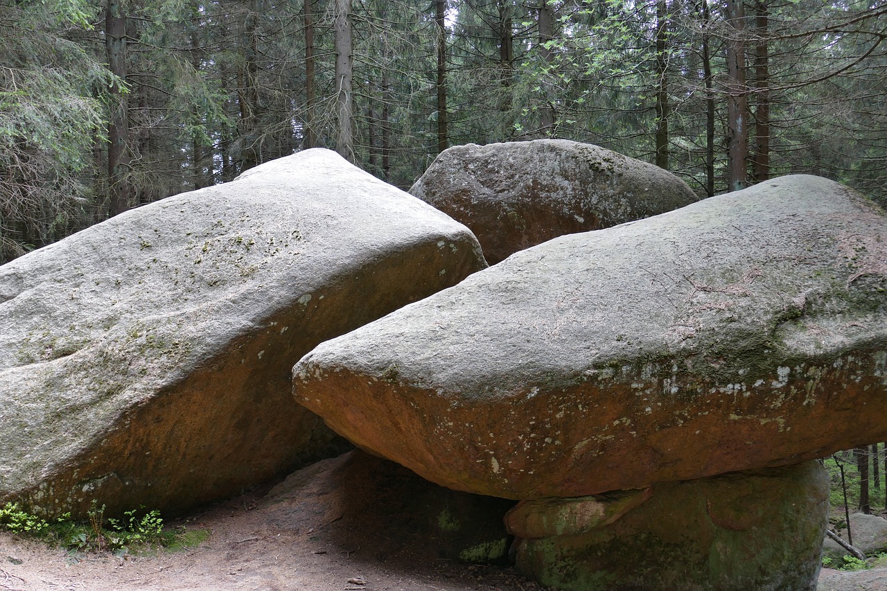 a couple of large rocks sitting on top of a dirt road, by Jan Stanisławski, flickr, naturalism, hidden in the forest, giant tomb structures, closeup - view, insanely inflated hips