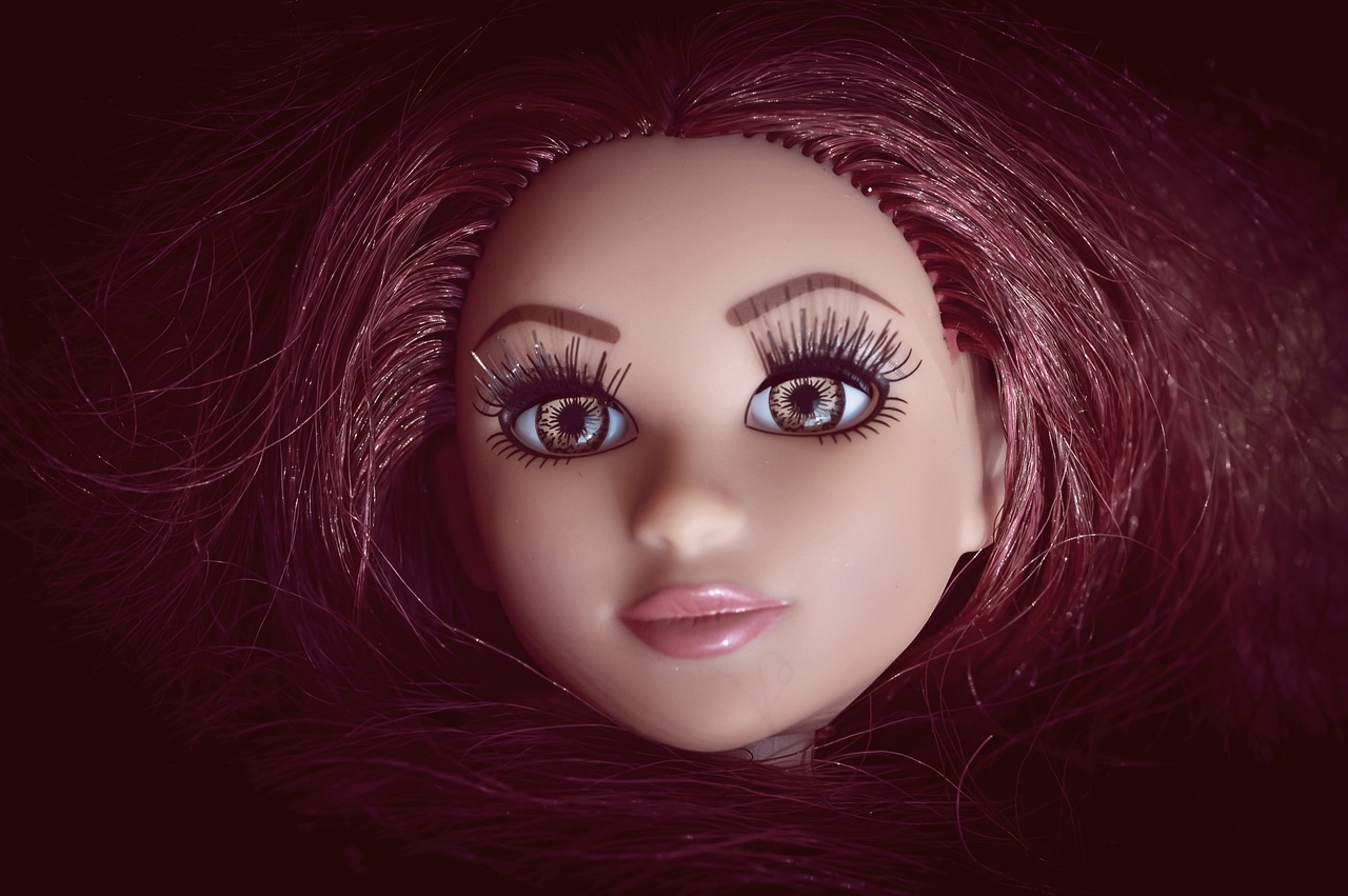 a close up of a doll with red hair, a portrait, inspired by David Gilmour Blythe, cg society contest winner, pop art, looks like britney spears, animatronic angelina jolie, plastic barbie doll, full face frontal centred