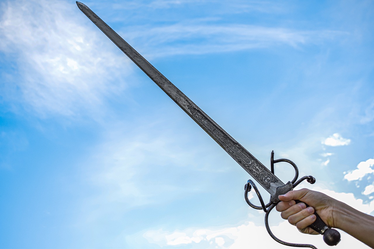 a close up of a person holding a sword, by Edward Corbett, shutterstock, sword pointed at sky, highly detailed product photo, realistic weapons, ultra wide-shot