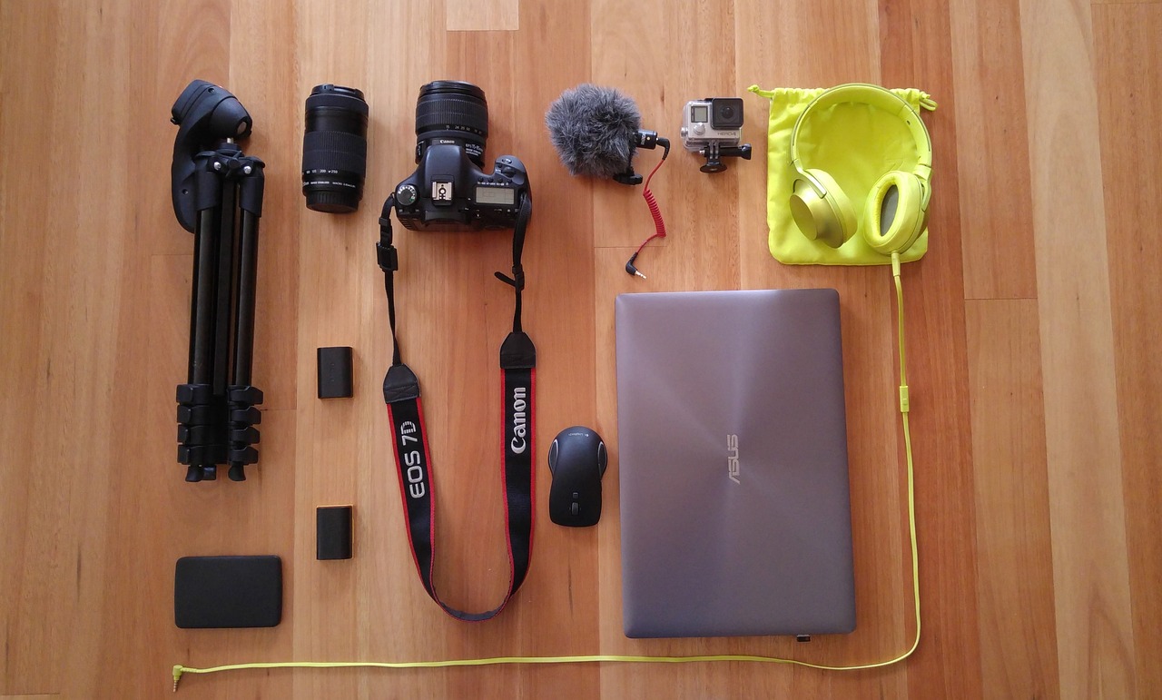 a laptop computer sitting on top of a wooden floor, a picture, by Adam Manyoki, various items, gear, posing for camera, journalist photo