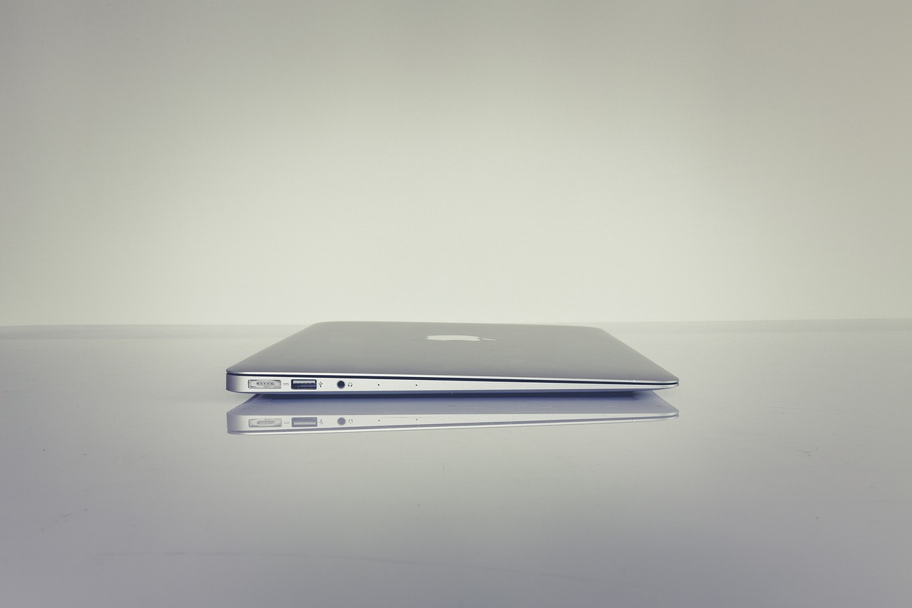 a laptop computer sitting on top of a table, a picture, by Karl Buesgen, minimalism, side shot, very thin, low - angle, shiny silver