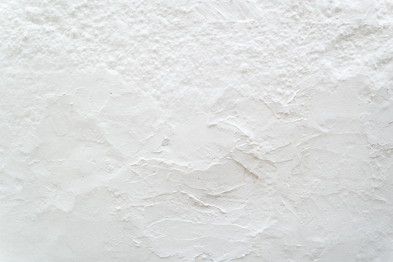 a man riding skis down a snow covered slope, an ultrafine detailed painting, minimalism, white stone wall background, surface with beer-texture, covered in white flour, close-up product photo