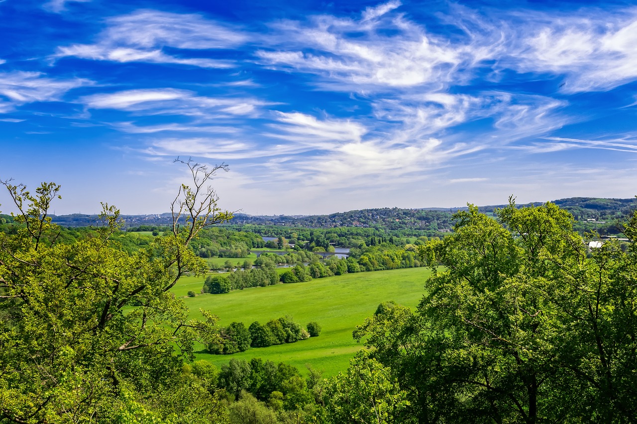 a view of the countryside from the top of a hill, a stock photo, renaissance, esher, green and blue colors, stunning nature in background, vibrant and vivid