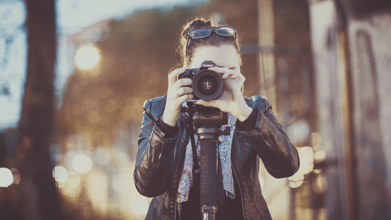a woman taking a picture with a camera, cameras lenses, flickr photography, paparazzi photo, professional dslr photo