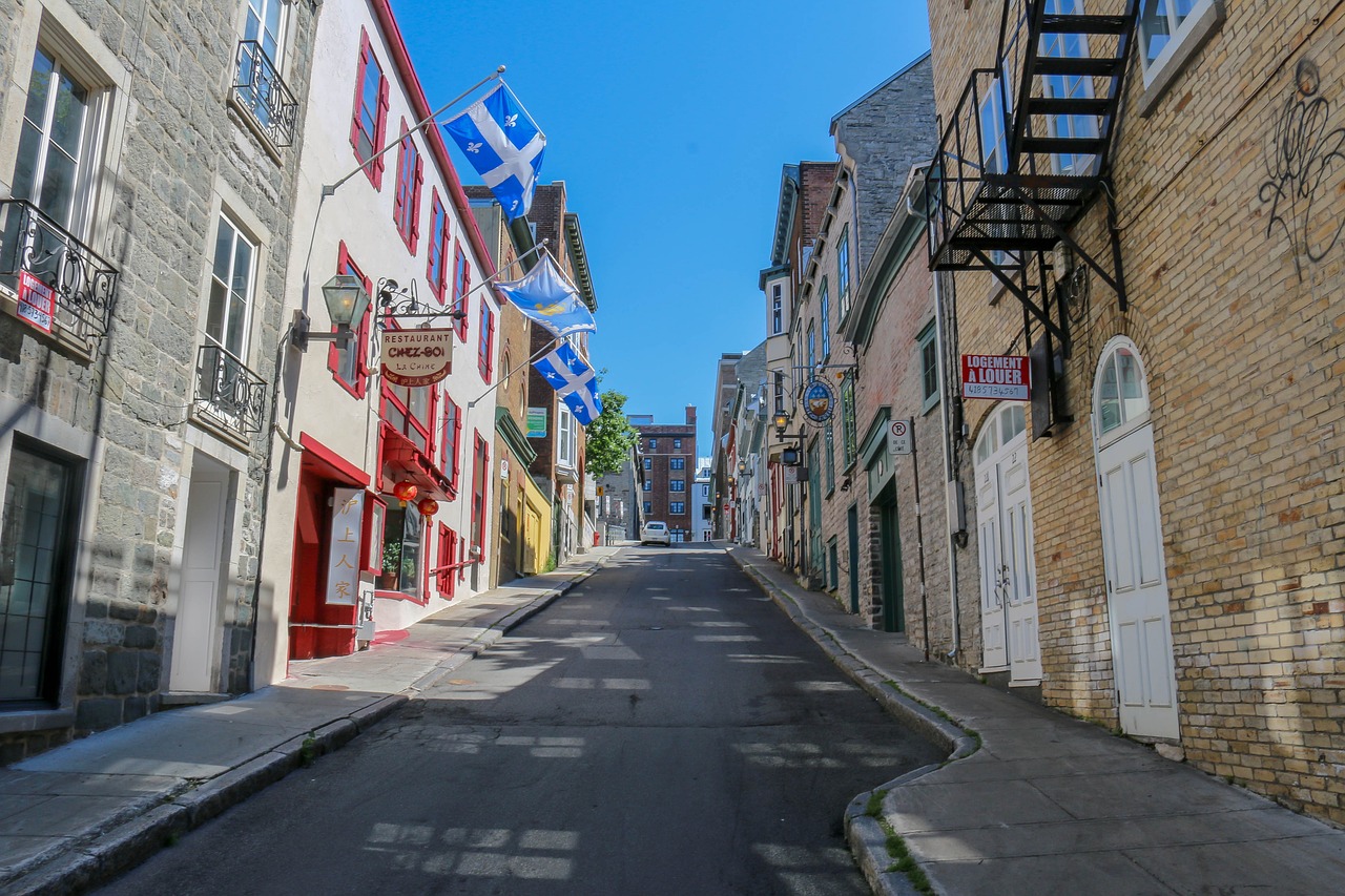 a narrow street lined with buildings and flags, quebec, usa-sep 20, deserted, tourist photo