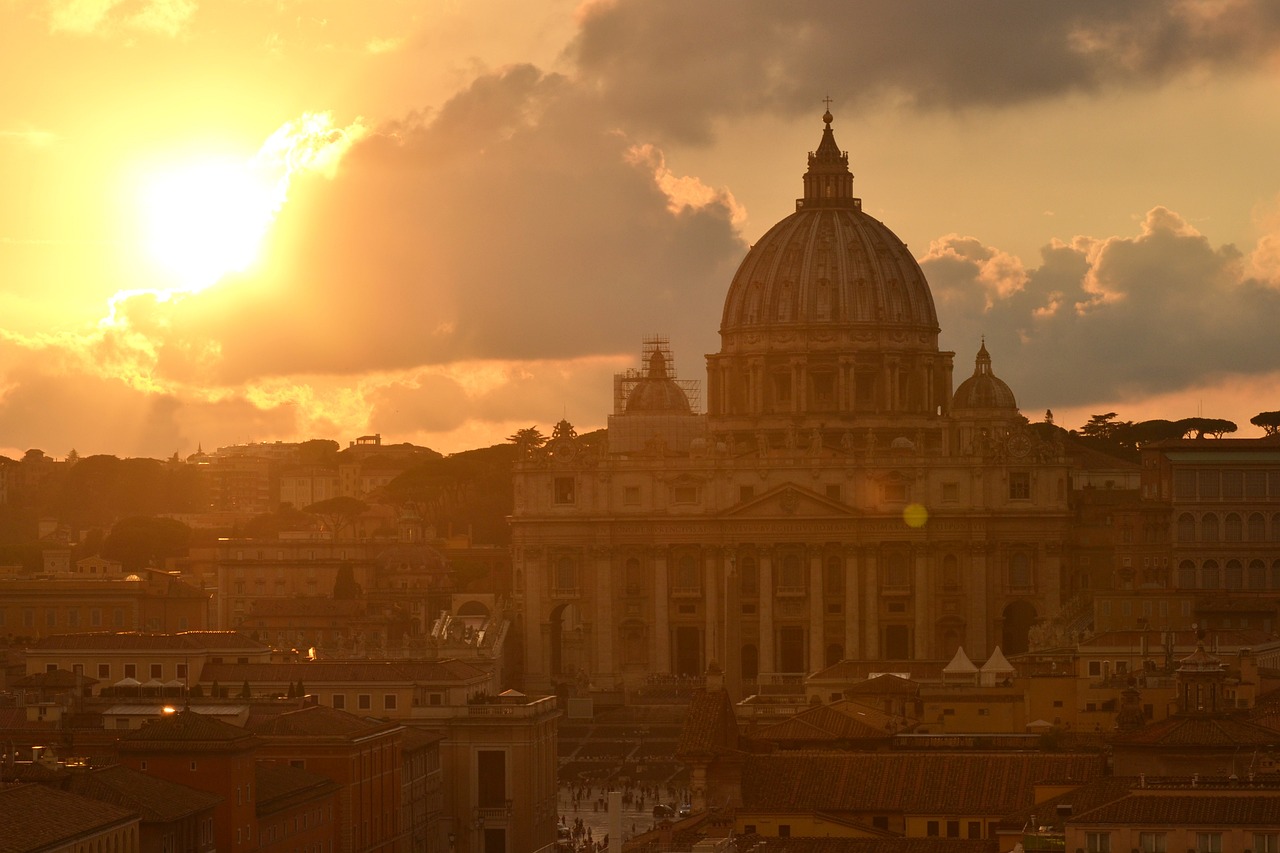 the sun is setting behind the dome of a building, a picture, by Cagnaccio di San Pietro, shutterstock, john paul ii, wikimedia commons, visible from afar!!, unedited