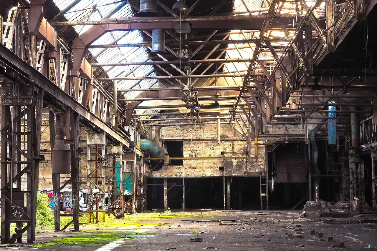 a view of the inside of an abandoned factory, by Richard Carline, intense sunlight, industrial colours, glasgow, yard