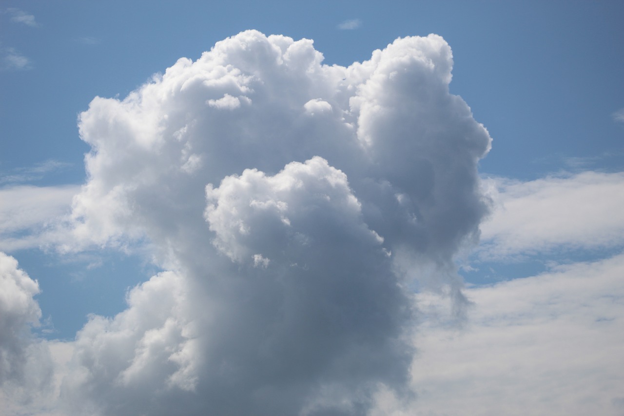 a jetliner flying through a cloudy blue sky, a portrait, by Linda Sutton, shutterstock, romanticism, giant cumulonimbus cloud, white cyclops portrait in sky, close - up profile, detailed zoom photo