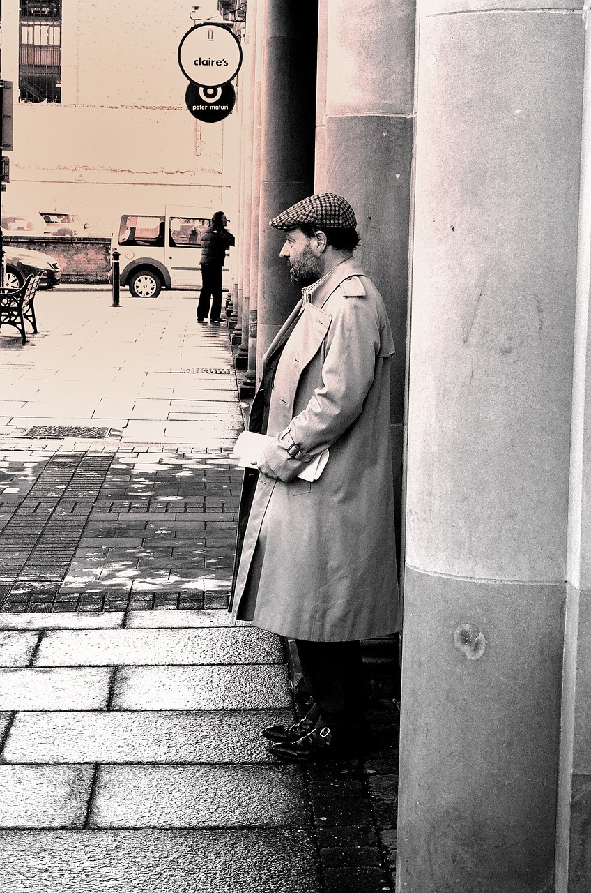a black and white photo of a man in a trench coat, inspired by Henri Cartier-Bresson, flickr, old cmputers on the sidewalk, flat colour, the librarian, waiting patiently