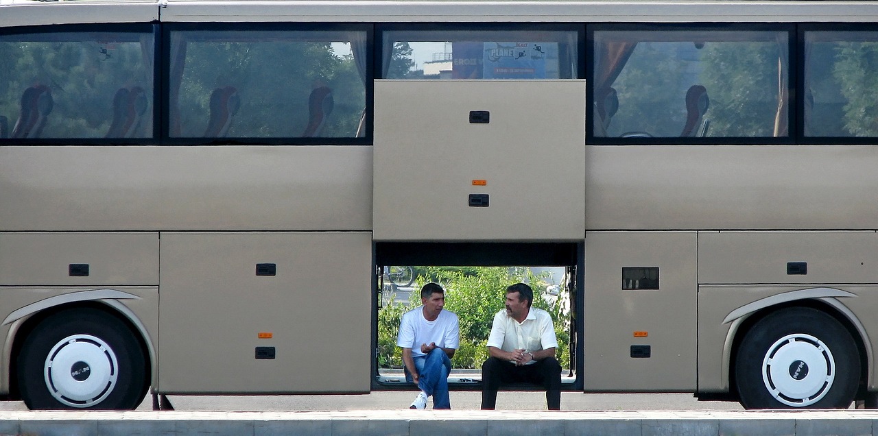 two people sitting on a bench in front of a bus, by Jan Rustem, flickr, missing panels, azamat khairov, sitting at a control center, minimal composition