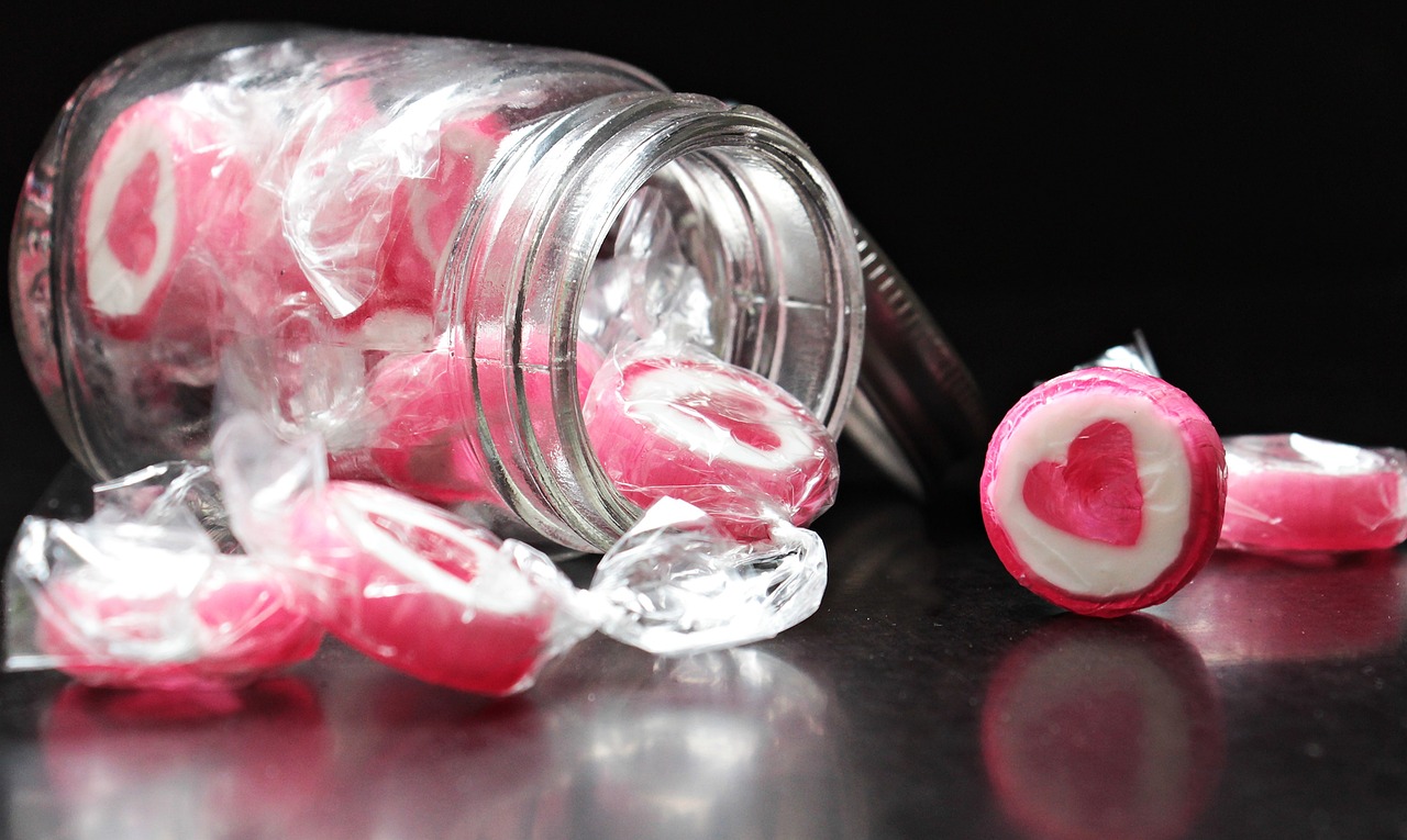 a jar filled with candy sitting on top of a table, inspired by Władysław Podkowiński, pexels, process art, pink arches, jello, photorealism. trending on flickr, tear drops