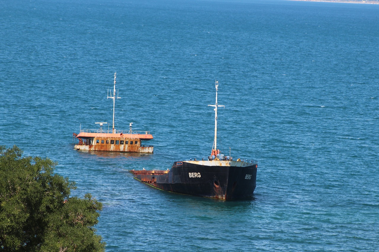a couple of boats that are in the water, hurufiyya, black sea, utilitarian cargo ship, chocolate, unusual composition
