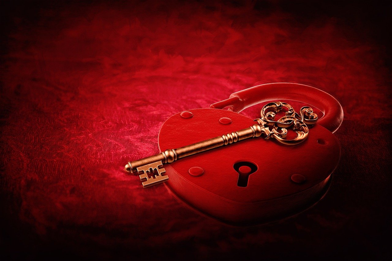 a heart shaped box with a golden key on it, romanticism, blood red background, amazing wallpaper, the key of the nile, highly detailed product photo