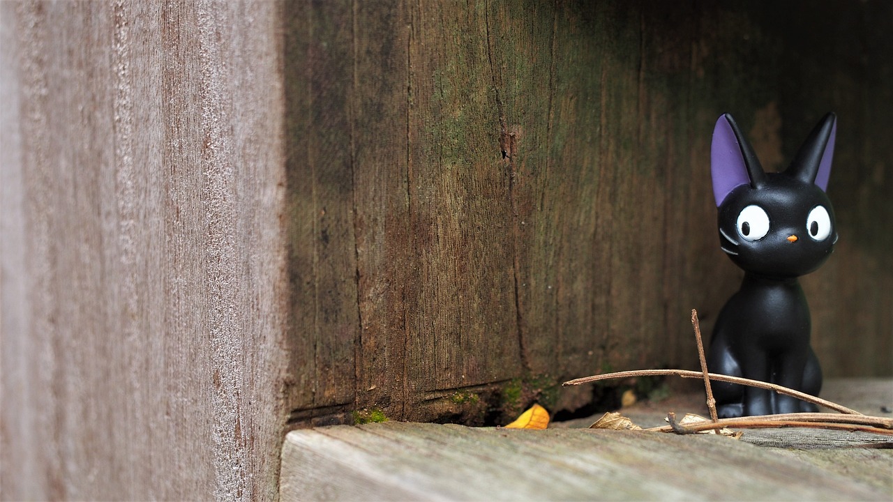 a close up of a figurine of a cat, by Richard Carline, rough wooden fence, miniature photography closeup, wood door, ant view