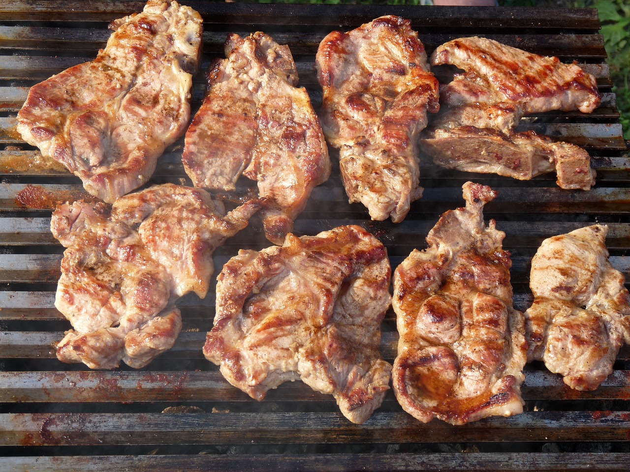 a bunch of meat sitting on top of a grill, shutterstock, figuration libre, romanian, view from slightly above, outdoor photo, panels