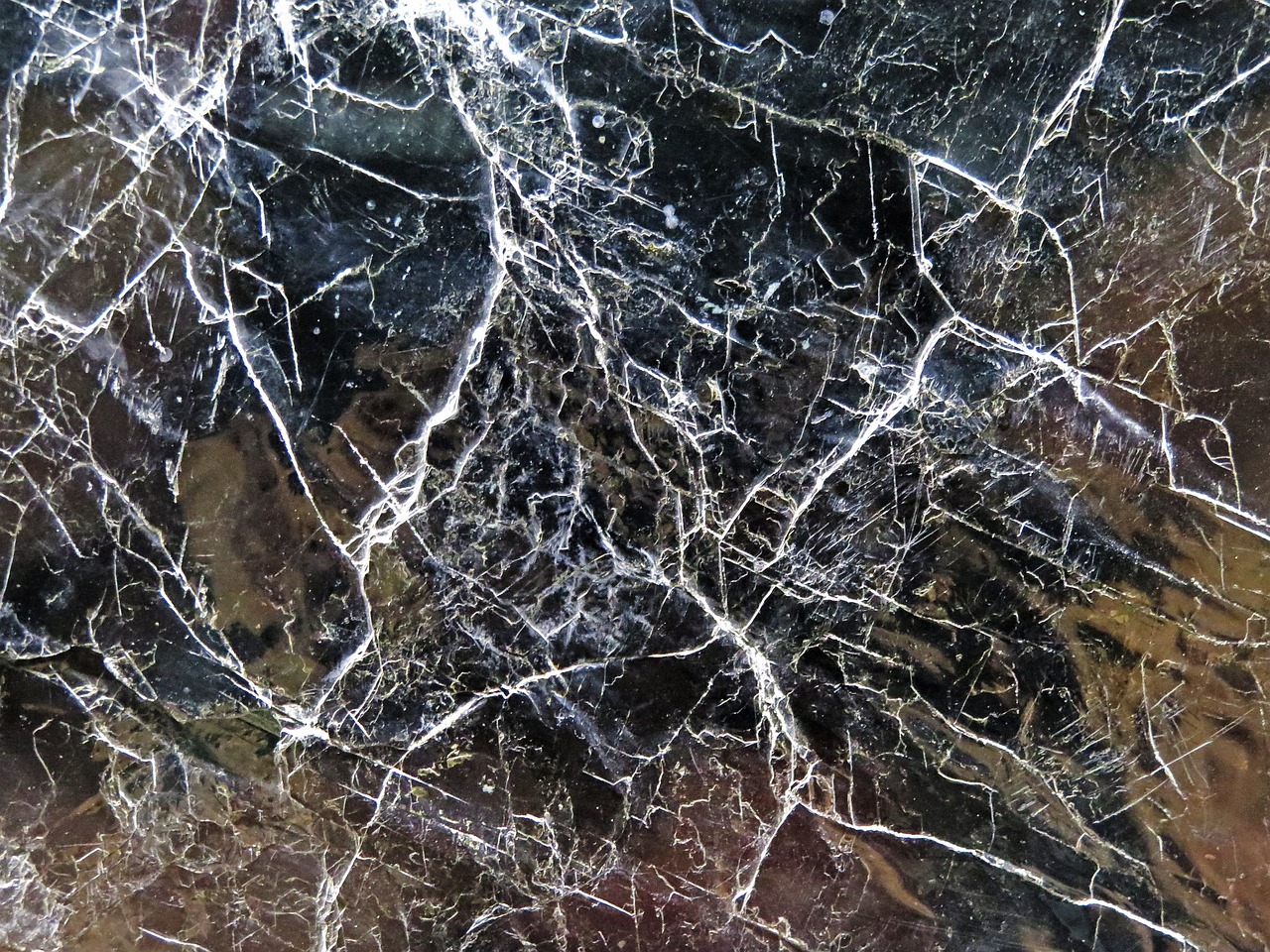 a close up view of a marble surface, by Hans Fischer, abstract expressionism, spiderwebs, background ( dark _ smokiness ), glassy fracture, visible nervous system