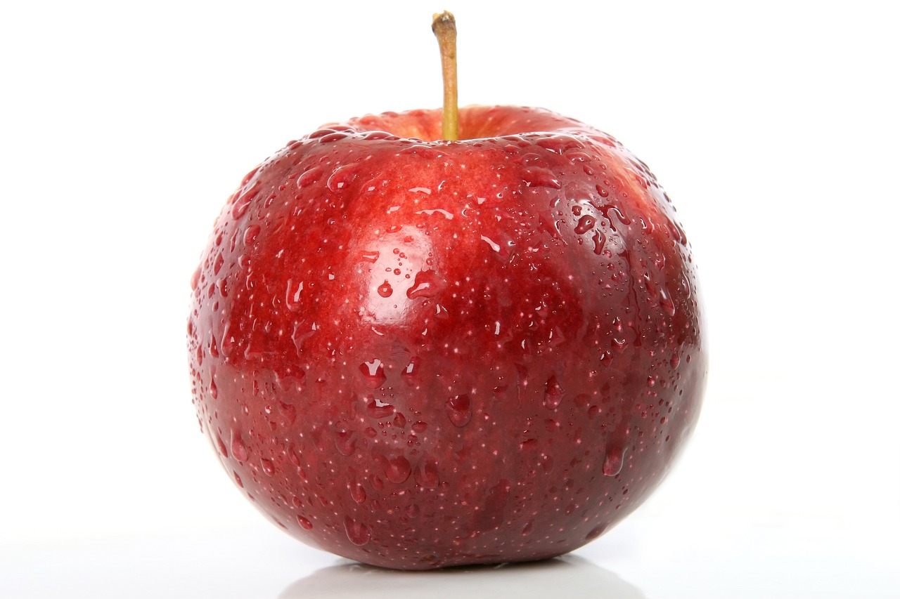 a red apple sitting on top of a white surface, a picture, istockphoto, wet, a close up shot, fully covered