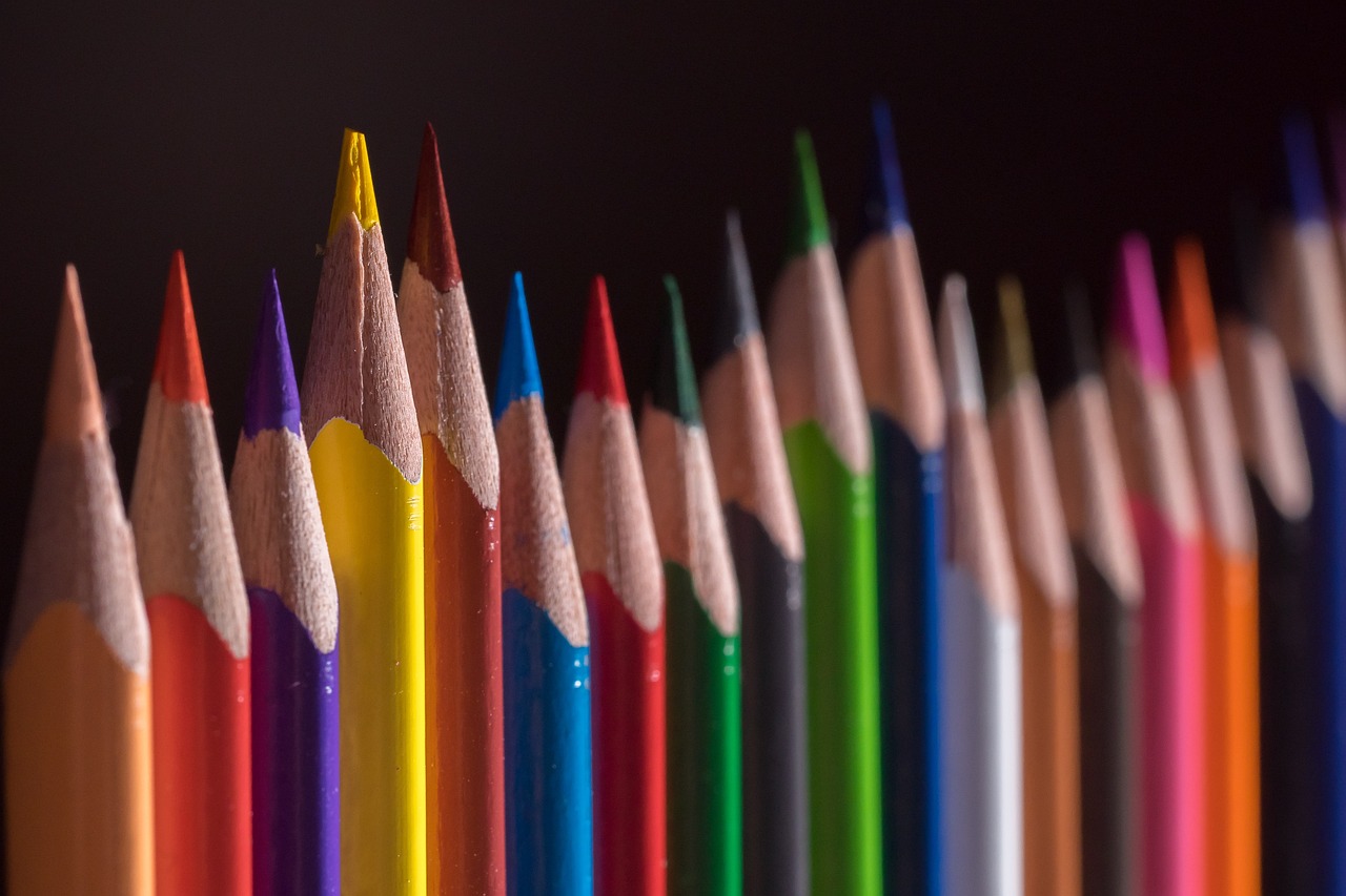 a close up of a row of colored pencils, by Richard Carline, crayon art, photo taken with sony a7r, today\'s featured photograph 4k, excellent composition, colorful and dark