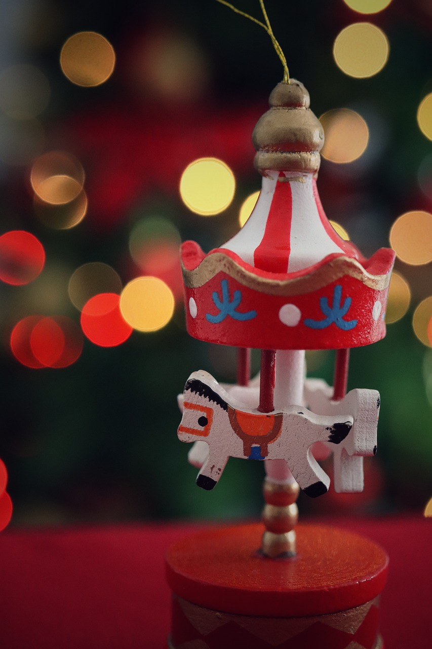 a close up of a toy carousel with lights in the background, pexels contest winner, folk art, christmas tree, pony, an artistic pose, 3 4 5 3 1