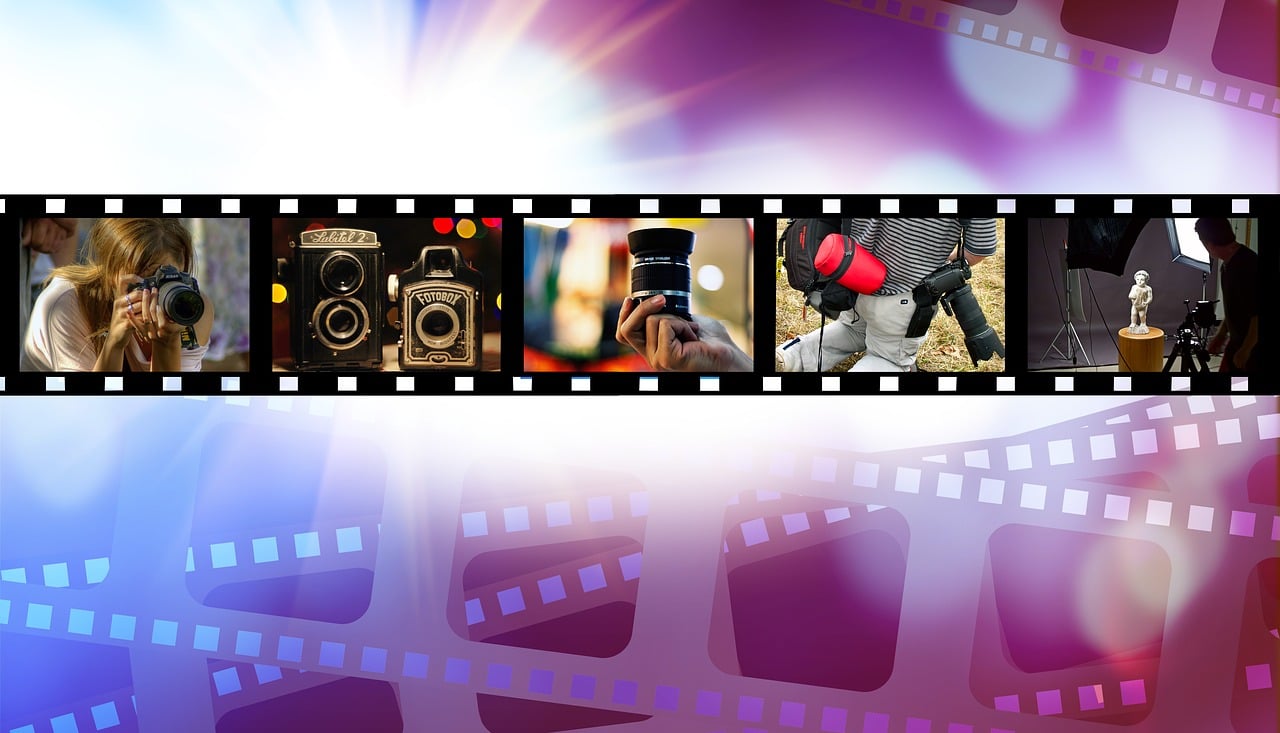 a close up of a film strip with a camera, a picture, by Douglas Shuler, pixabay, video art, posing elegantly over the camera, vibrant scene, holding a camera, film stills