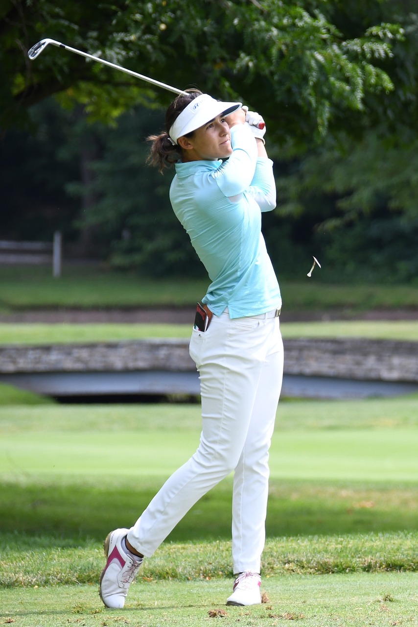 a woman in a blue shirt and white pants playing golf, shin hanga, portrait sophie mudd, profile pic, rectangle, flying shot