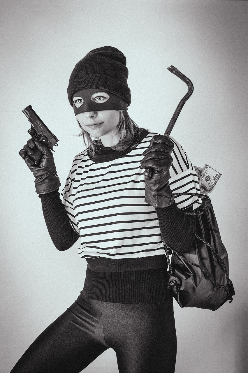a black and white photo of a woman holding a gun, a black and white photo, by Emma Andijewska, shutterstock, fine art, bank robbery, striped, cosplay photo, stock photo