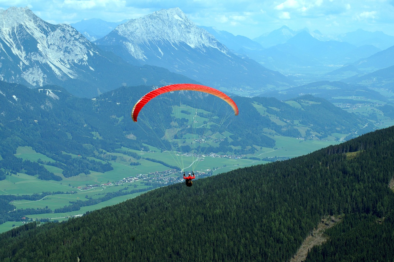 a person paragliding in the mountains on a sunny day, a picture, by Hans Schwarz, shutterstock, shot on kodak vision 200t, no gradients, brochure, stock photo