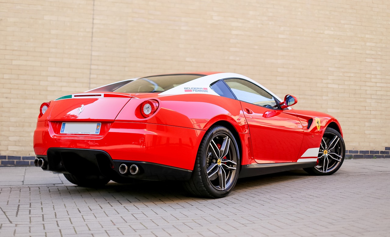 a red sports car parked in front of a brick building, a photo, inspired by Bernardo Cavallino, tumblr, 3 / 4 view from back, ferrari, immaculate detail, full growth from the back