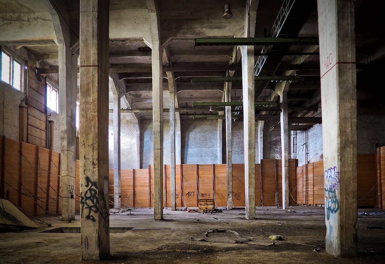 an empty building with lots of graffiti on the walls, by Thomas Häfner, flickr, concrete pillars, factory floor, ((rust)), postprocessed