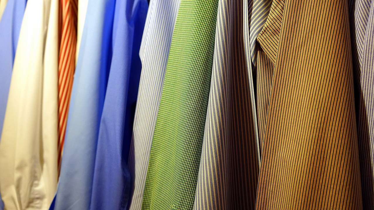 a closet filled with lots of different colored shirts, by Jan Rustem, flickr, business attire, green and brown clothes, morning detail, sun coast