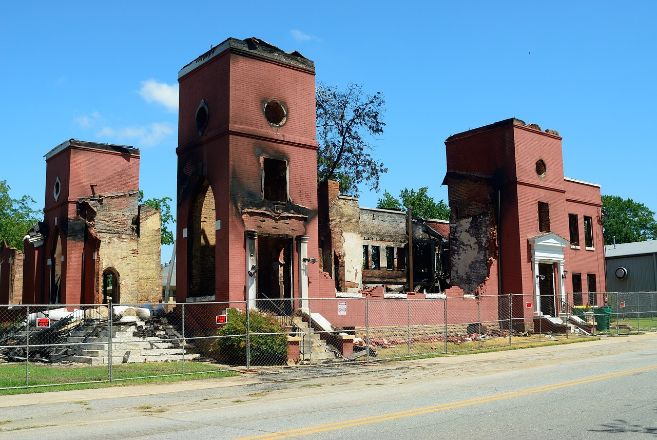 a large brick building sitting on the side of a road, by Tom Carapic, flickr, burned, alabama, destroyed church, masonic lodge