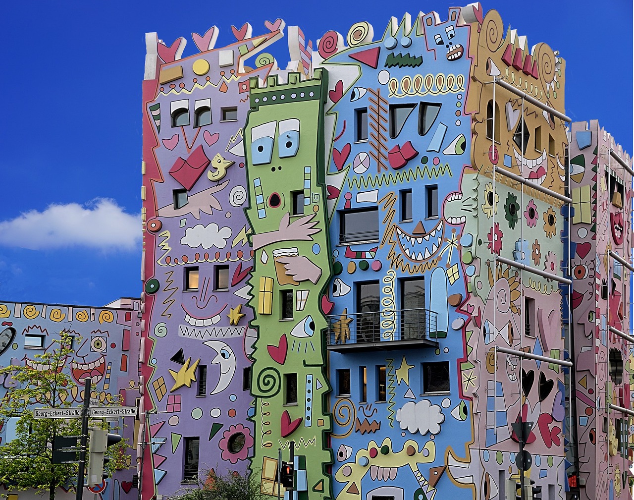 a multicolored building with a blue sky in the background, graffiti art, by Hundertwasser, trending on pixabay, street art, buildings covered with greebles, graffiti monster, flat color, very very well detailed image