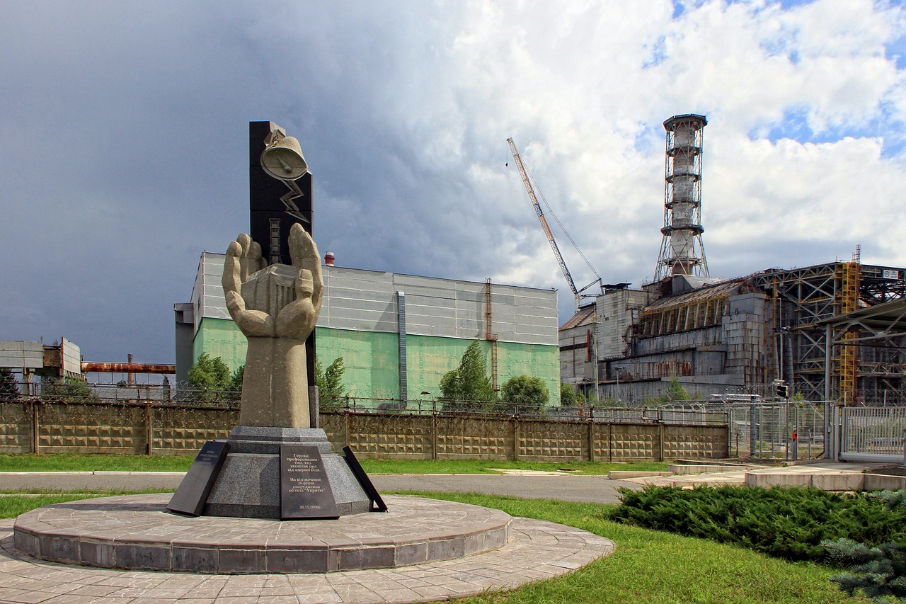 a statue of a hand holding a clock in front of a factory, a portrait, nuclear art, great king of stovokor, reactor core, unfinished, toward to the camera