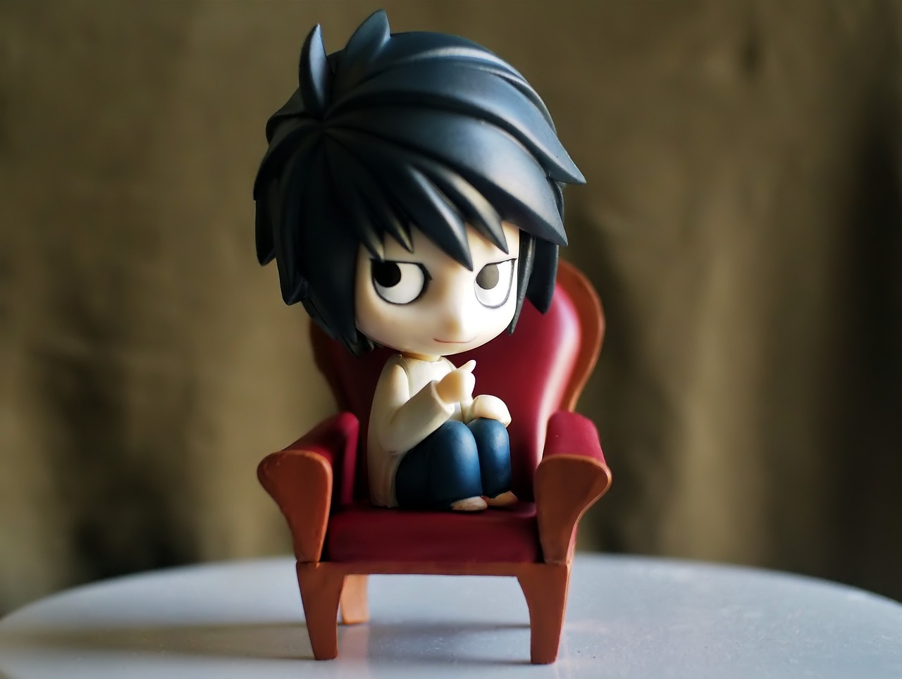 a figurine of a person sitting in a chair, a picture, inspired by Takeshi Obata, pixiv, vanitas, toy commercial photo, l · lawliet, toy photo, bashful expression