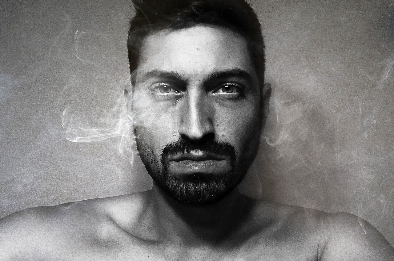 a black and white photo of a man with a beard, a portrait, by Lucia Peka, hyperrealism, hyperrealistic smoke, a portrait of rahul kohli, portrait of a young italian male, smoldering