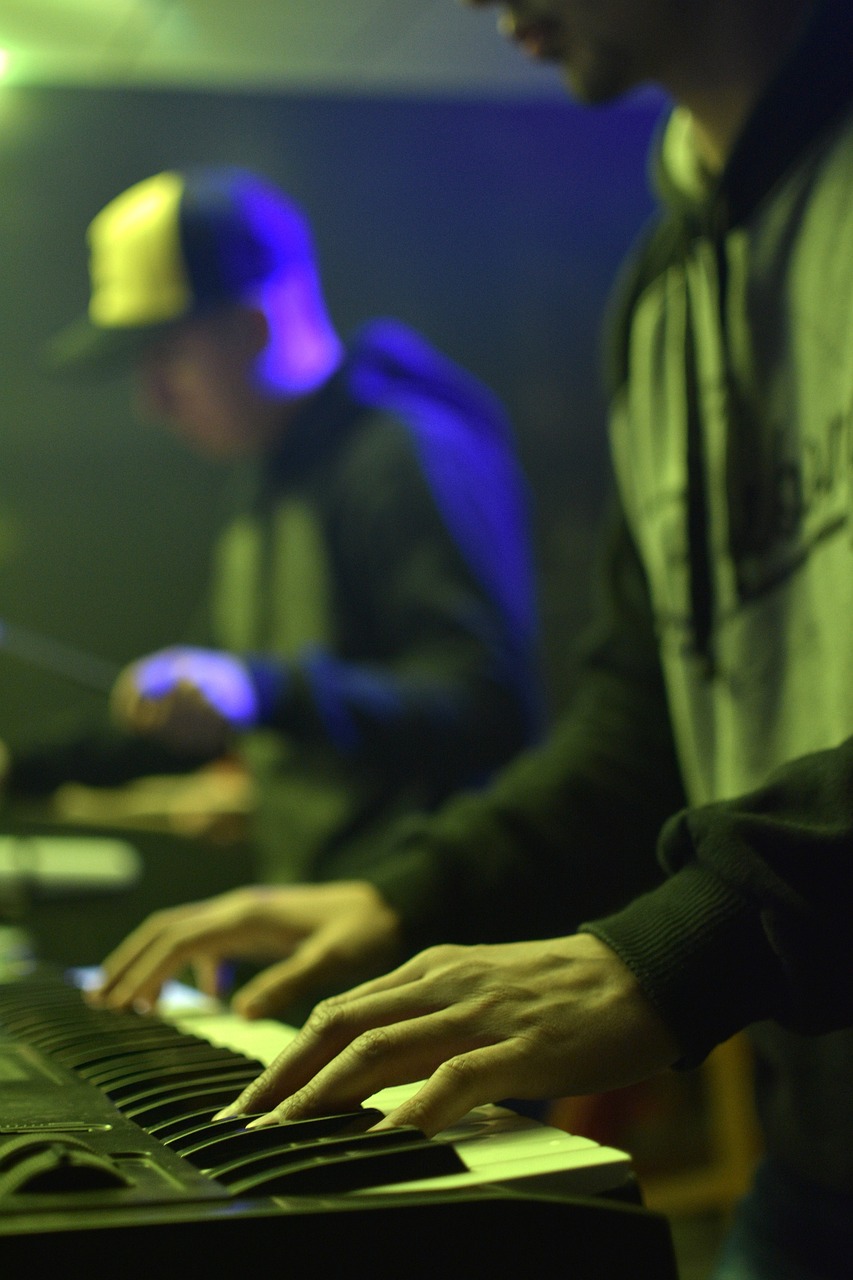 a close up of a person playing a keyboard, a portrait, synchromism, 2 rappers on stage at concert, taken in night club, school class, focused photo