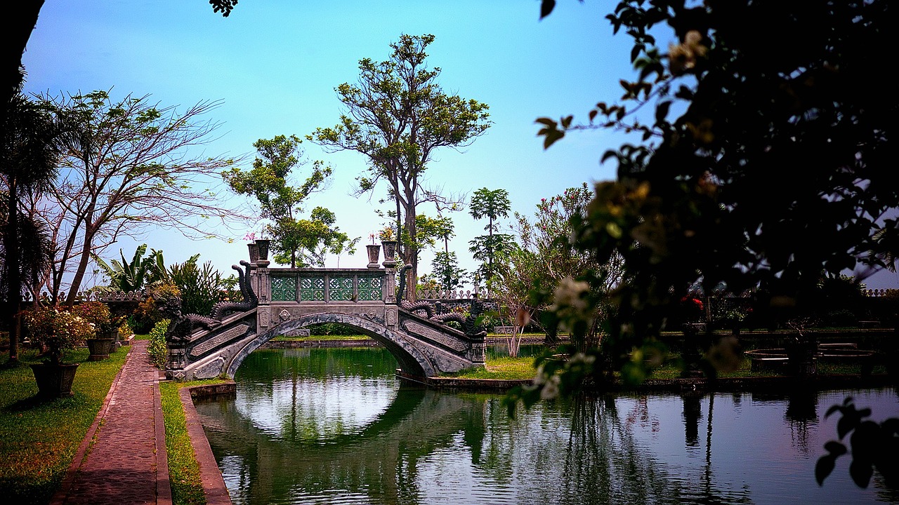 a bridge over a body of water surrounded by trees, a picture, by Ju Lian, flickr, bali, brocade, perfect spring day with, fujicolor photo